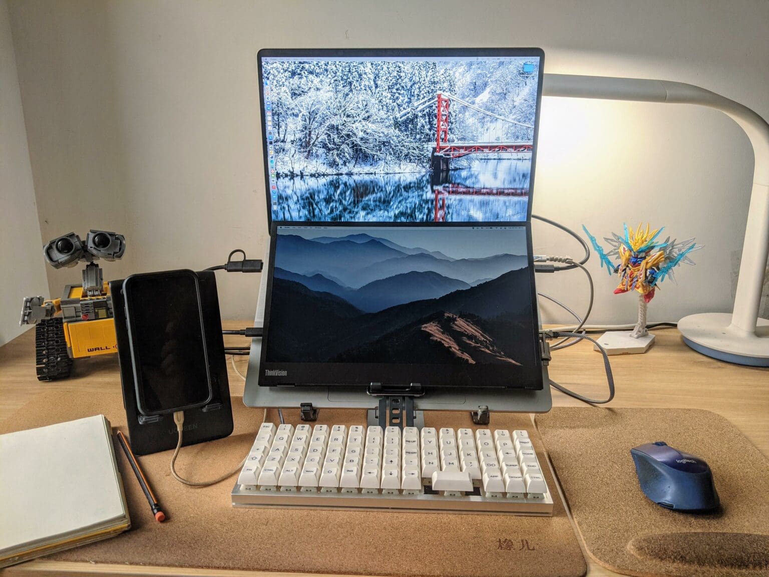 A portable monitor is mounted over the MacBook Pro's keyboard and an ortholinear-layout keyboard is the main input device.