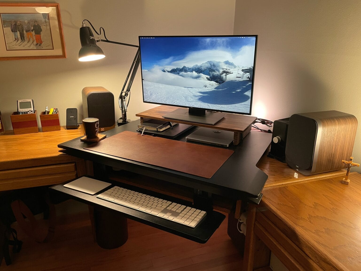 This M1 Pro MacBook setup uses a 27-inch Dell monitor and a pumped-up audio rig.